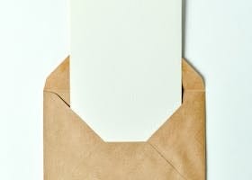 Minimalist brown envelope showcasing a blank card insert - perfect for invitations or greetings.